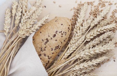 Fresh bread and wheat on the white woodenの写真素材