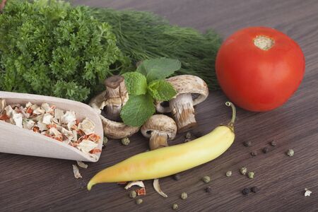mushrooms with vegetables on a wooden backgroundの写真素材