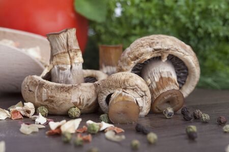 mushrooms with vegetables on a wooden backgroundの写真素材