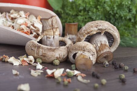 mushrooms with vegetables on a wooden backgroundの写真素材