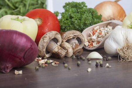 mushrooms with vegetables on a wooden backgroundの写真素材