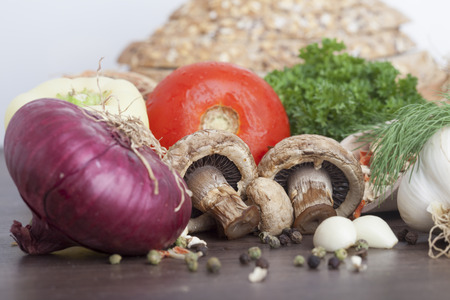 mushrooms with vegetables on a wooden backgroundの写真素材
