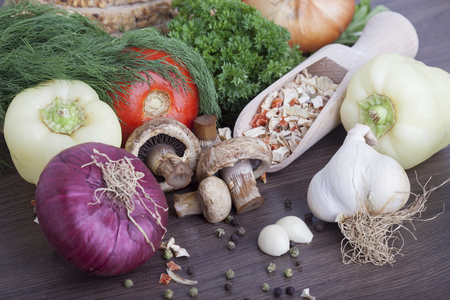 mushrooms with vegetables on a wooden backgroundの写真素材