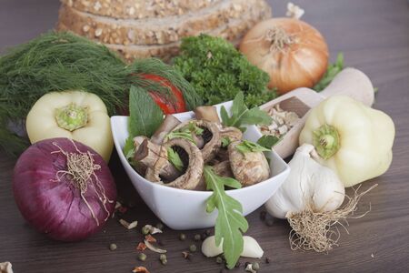 mushrooms with vegetables on a wooden backgroundの写真素材