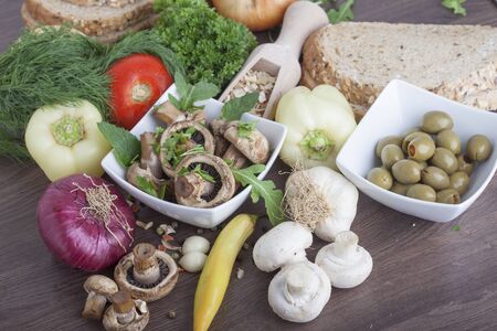 mushrooms with vegetables on a wooden backgroundの写真素材