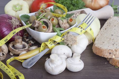 mushrooms with vegetables on a wooden backgroundの写真素材