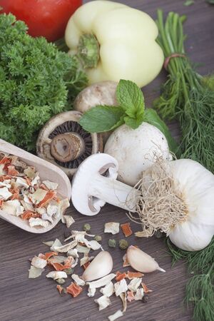 mushrooms with vegetables on a wooden backgroundの写真素材