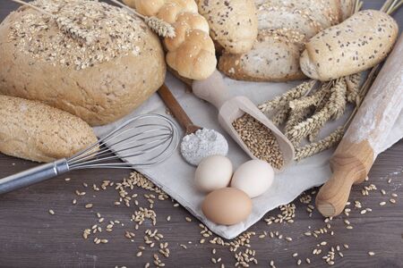 fresh bread and wheat on the woodenの写真素材