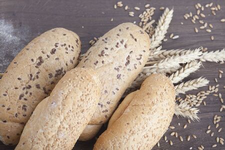 fresh bread and wheat on the woodenの写真素材