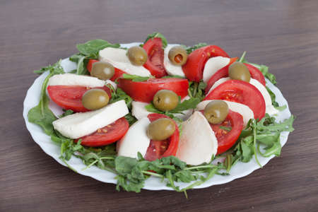 Caprese salad with mozarella cheese, tomatoes , olives and mushroomsの写真素材