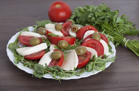 Caprese salad with mozarella cheese, tomatoes , olives and mushroomsの写真素材