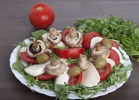 Caprese salad with mozarella cheese, tomatoes , olives and mushroomsの写真素材