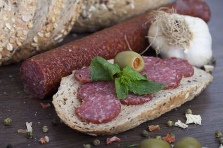 sausage cut into slices on a wooden boardの写真素材
