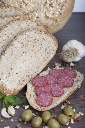 sausage cut into slices on a wooden boardの写真素材