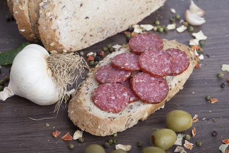 sausage cut into slices on a wooden boardの写真素材