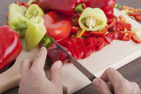 Cook is chopping bell pepper, closeup shootの写真素材