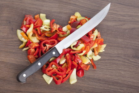 Heart shape chopped peppers on a wooden backgroundの写真素材