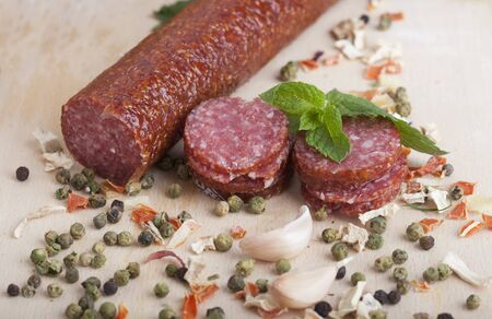 sausage cut into slices on a wooden boardの写真素材