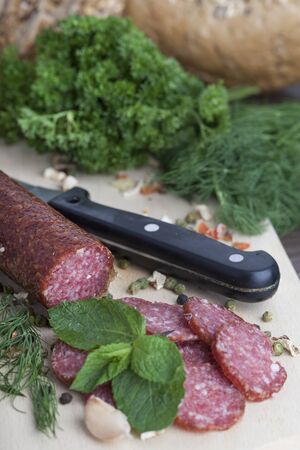 sausage cut into slices on a wooden boardの写真素材