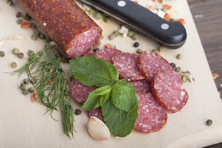sausage cut into slices on a wooden boardの写真素材