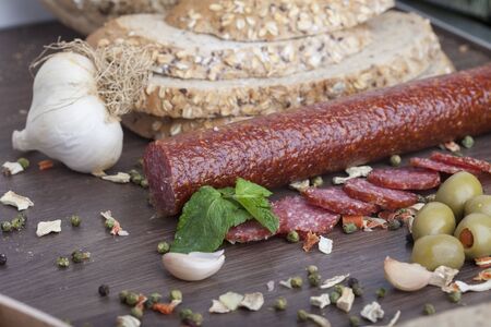 sausage cut into slices on a wooden boardの写真素材