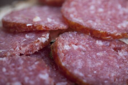 sausage cut into slices on a wooden boardの写真素材
