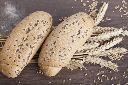 fresh bread and wheat on the woodenの写真素材