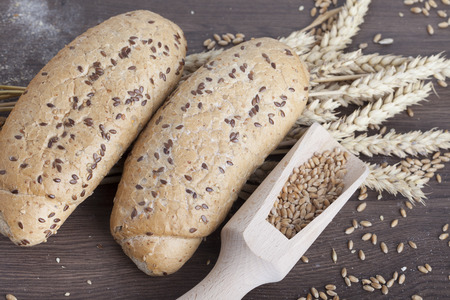 fresh bread and wheat on the woodenの写真素材
