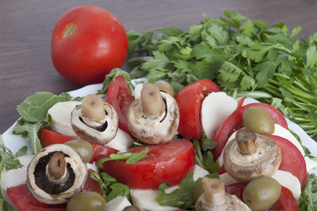 Caprese salad with mozarella cheese, tomatoes , olives and mushroomsの写真素材