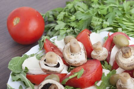 Caprese salad with mozarella cheese, tomatoes , olives and mushroomsの写真素材