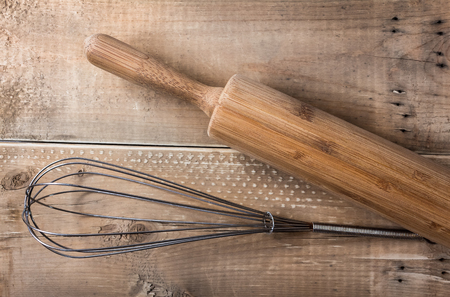 Top view of whisk and rolling pin baking utensils on wooden backgroundの写真素材