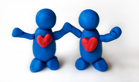 Blue clay people holding hands, united in harmonyの写真素材