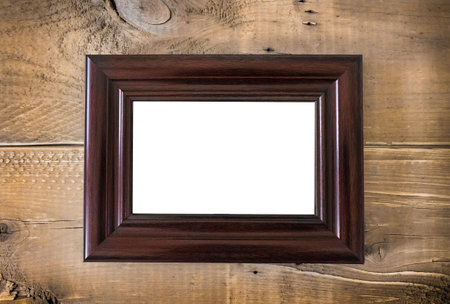 Blank brown picture frame on wooden background