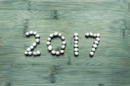 New year 2017 beads on green wooden backgroundの写真素材