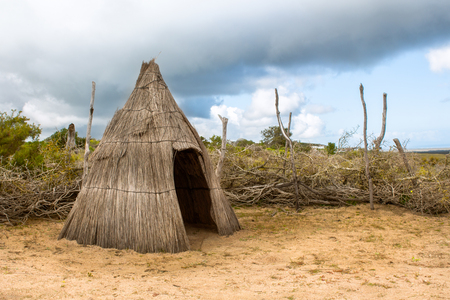 !Khwa ttu San Culture and Education Centre, Yzerfontein, West Coast, South Africa - August 28th, 2018. A traditional San Bushmen hut is illustrated in a mockup village at the San heritage centre in Yzerfontein.のeditorial素材