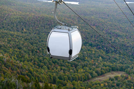 Cable car in autumn forest. View from the top of the mountain.の写真素材