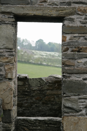 Landscape through a stone castle window in Scotlandの写真素材