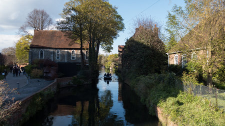Sunny day on the River Stour, Canterbury, with tourists taking a boat tripの写真素材