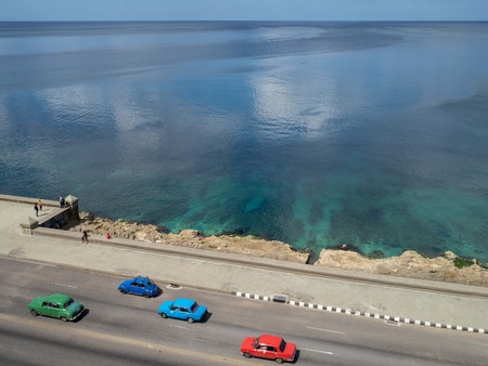 Classic cars driving down the Malcon in Havana, Cuba, aerial viewの写真素材