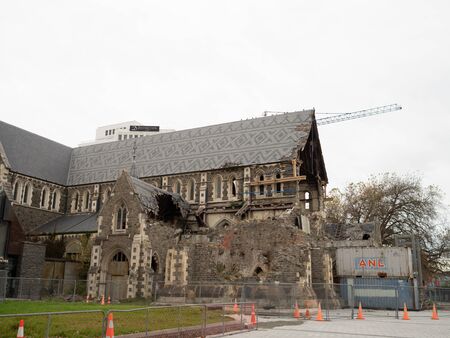 CHRISTCHURCH, NEW ZEALAND - May 2019: Dilapidated ruins of Christchurch Cathedral, damaged from the earthquake in 2011, awaiting repair with fencing and cones around it.のeditorial素材