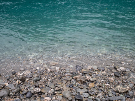 View of turquoise blue creek and stony shore
