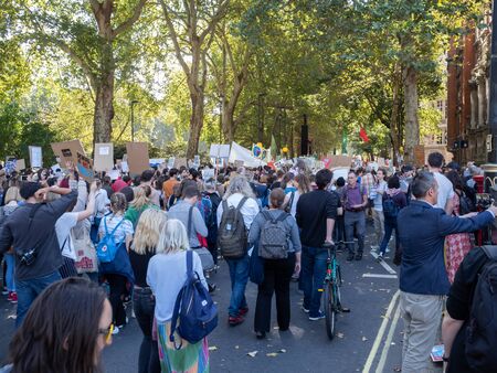 LONDON, UK - SEPTEMBER 20 2019: Crowd of people at the Global Climate Strike in London, holding placardsのeditorial素材
