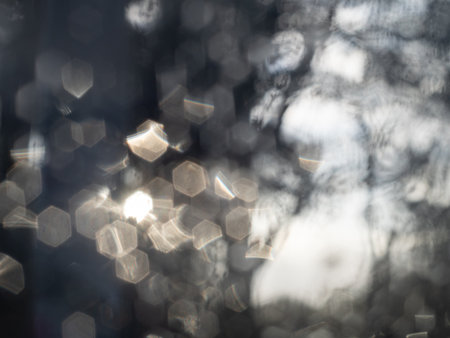 Soft gold hexagonal bokeh light through trees