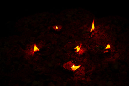 Floor decorated with flowers and diyas on the occasion of diwali