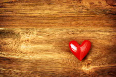 Shiny red heart on wooden backgroundの写真素材