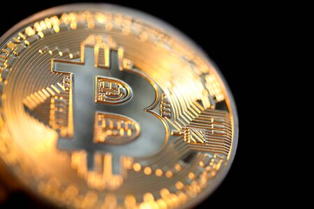Close up of a single shiny bitcoin coin.  Wealth, digital, virtual, currency, and cryptocurrency concept.の写真素材