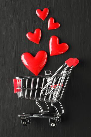 Collection of shiny red hearts in a shopping cartの写真素材