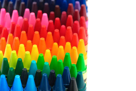 Box of crayons in a rainbow of colors with blank white spaceの写真素材