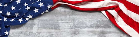 US American flag on worn white wooden background. For USA Memorial day, Veteran's day, Labor day, or 4th of July celebration. With blank space for text.の写真素材
