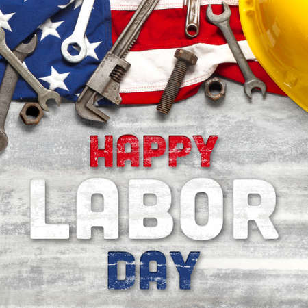 US American flag with work tools on worn white wooden background. For USA Labor day celebration. With Happy Labor Day text.の写真素材